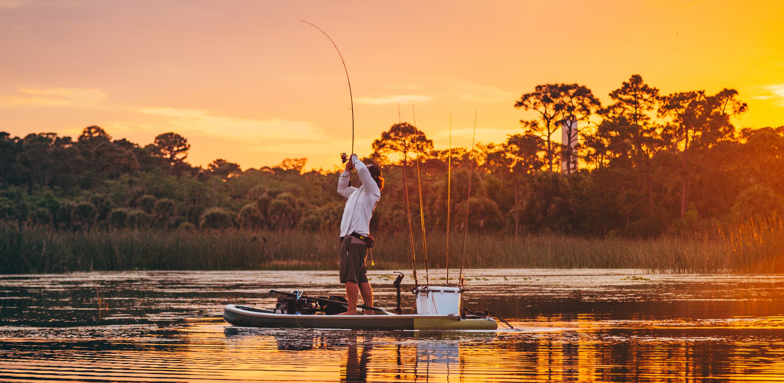 An angler fishing at golden hour